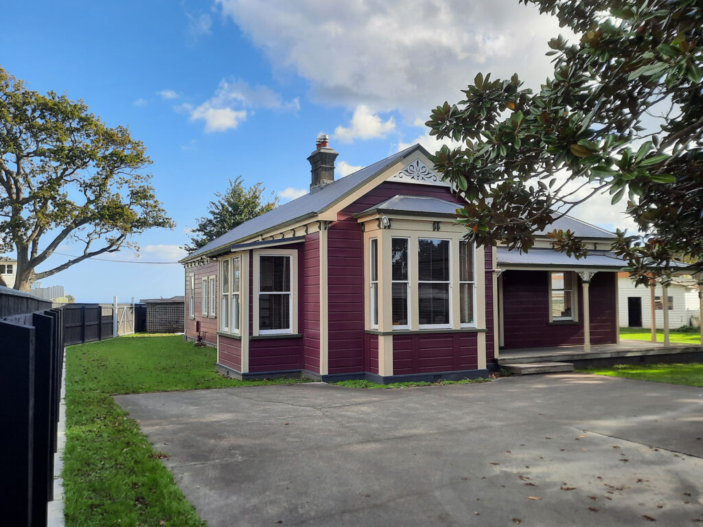 The exterior painting of this home was inspired by the colourful villas of San Francisco this old home was transformed with a colour pallet of Resene Mulberry, Kelp and Half Canterbury Clay