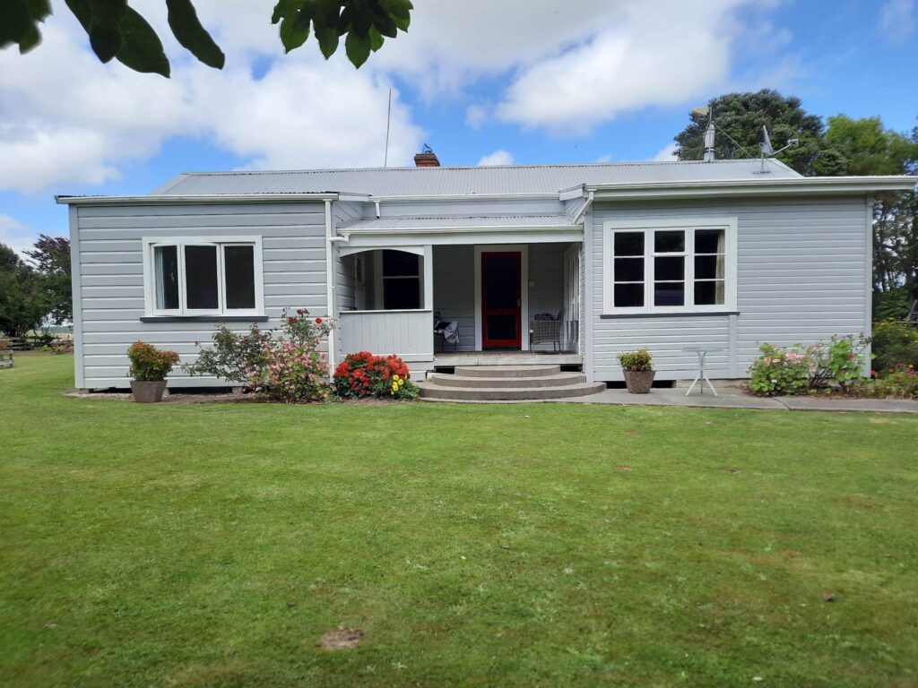 Professional exterior painting carried out on this project by the team of painters at Swish Decorating, with pewter grey walls of Resene Silver Chalice and showstopping spicy red doors in Resene Jalapeno.
