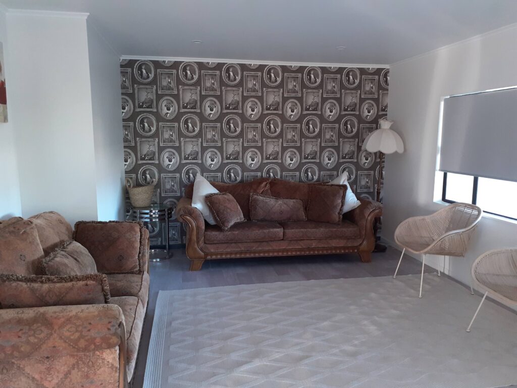 A fun and quirky feature wall featuring animal portraits, hung by the professional wallpaper hangers at Swish Decorating