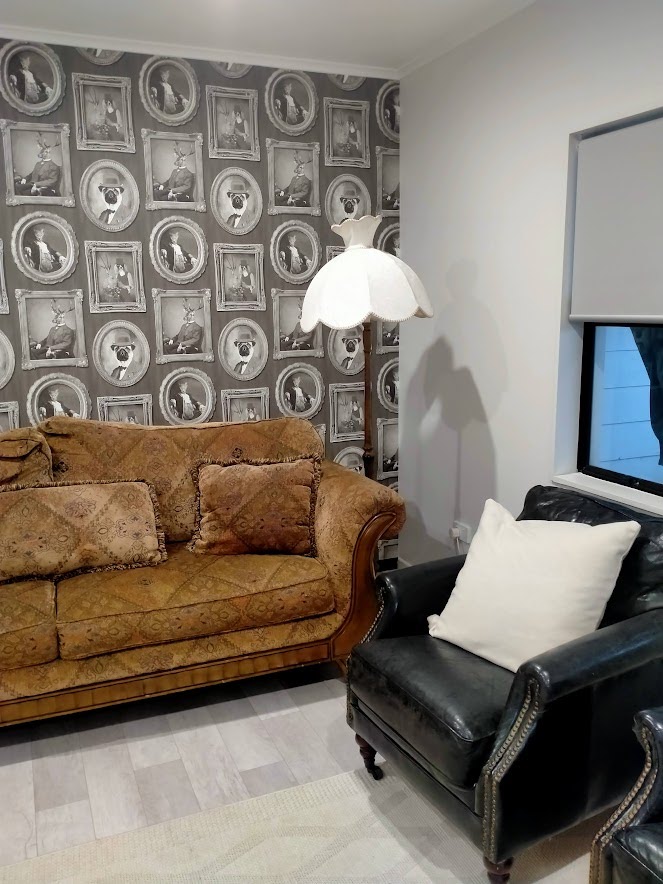 A fun and quirky feature wall featuring animal portraits, hung by the professional wallpaper hangers at Swish Decorating