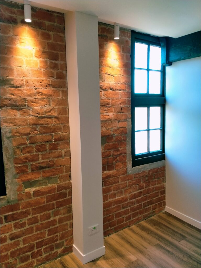 Restoration and conversion of the 1914 Johnston & Co building into apartments and office spaces with interior painting by the Swish Decorating team of quality painters