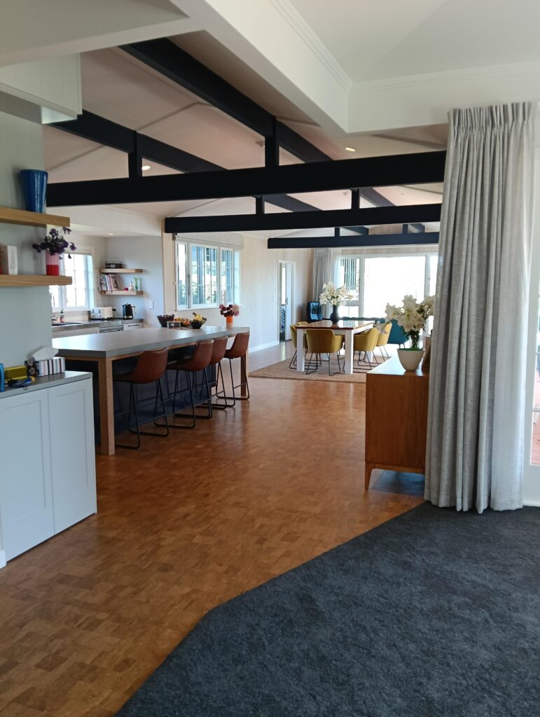 Complete interior renovation for these clients with a beautiful airy open plan living area featuring walls whitewashed in Resene Greywash, ceiling beams in Indian Ink and ceiling in Black White