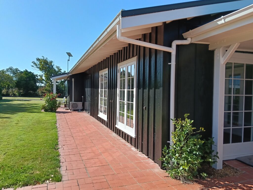 Exterior walls painted by the professional painters at Swish Decorating in Resene Black with trims in Black White