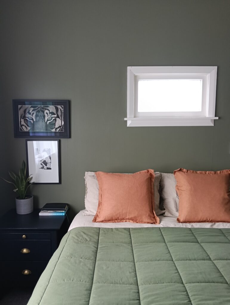 A calm and relaxing master bedroom with walls painted in the exotic green of Resene Siam