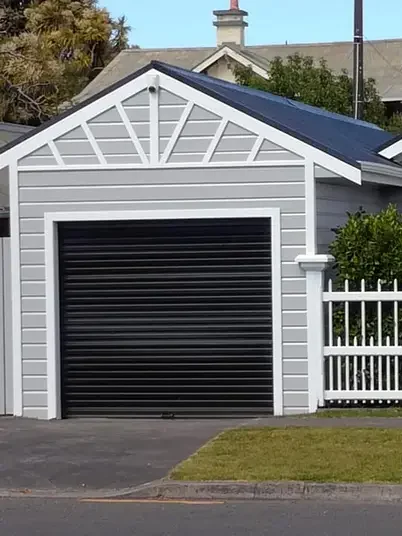 Swish Decorating painted the exterior of this garage and home in Resene Mountain Mist with trims in Black White, the roof was spray painted in Resene All Black